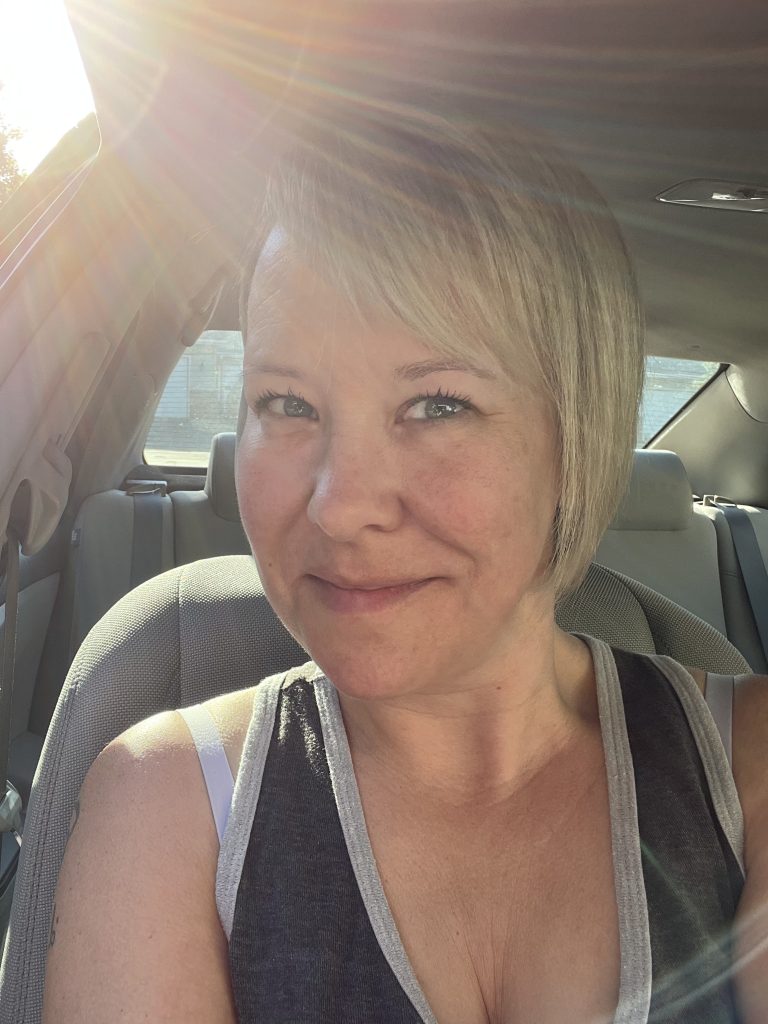 Close up of woman with light from sun on her face while sitting in a car